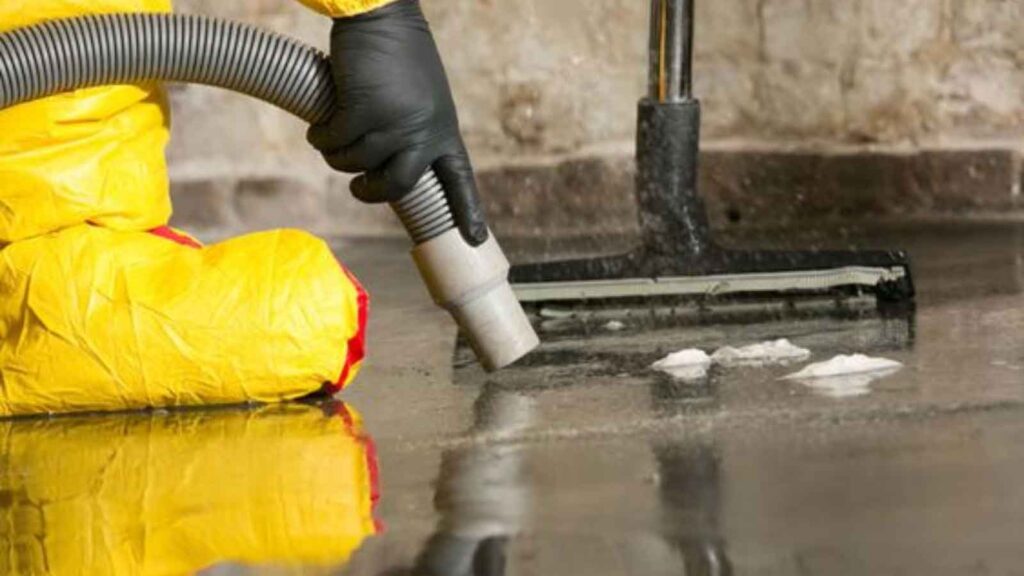 Technician extracting water from a flooded surface.