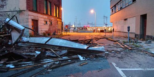 Debris from storm damage outside a commercial building.