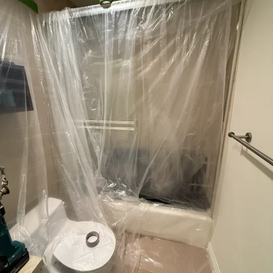 Professional containment setup using plastic barriers during mold remediation process