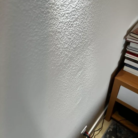 Wall texture showing water damage patterns requiring professional restoration and mold remediation services